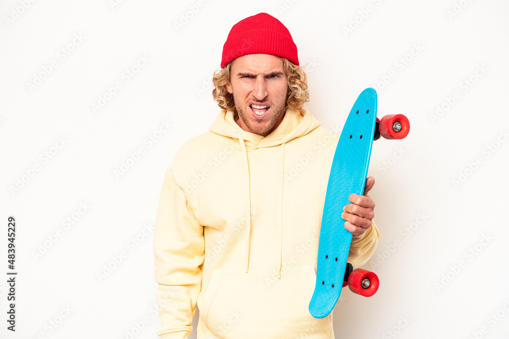 Young skater caucasian man isolated on white background screaming very angry and aggressive. Young skater caucasian man isolated on white background screaming very angry and aggressive.