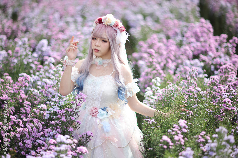 Fototapeta premium Beautiful young woman with white lolita dress with flowers garden Japanese fashion