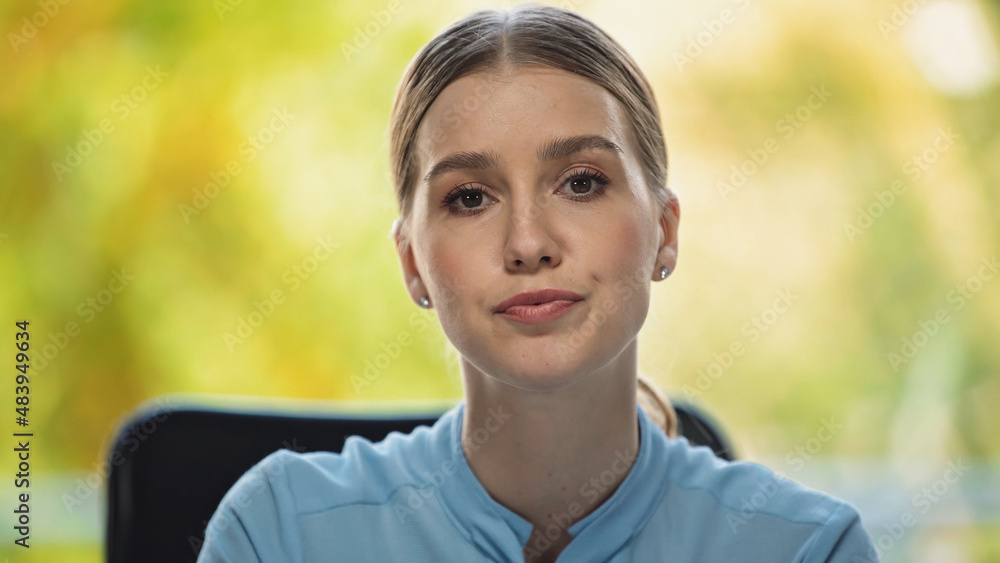 young and serious businesswoman looking at camera in office young and serious businesswoman looking at camera in office