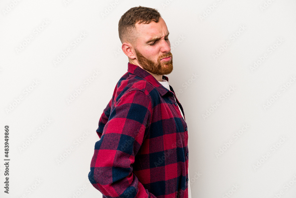 Young caucasian man isolated on white background suffering a back pain. Young caucasian man isolated on white background suffering a back pain.