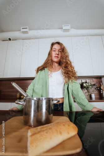 Young woman is preparing food in the kitchen. Prepare Food.