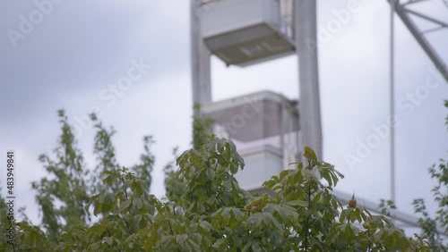Wallpaper Mural Green bushes in the park against the rotating ferris wheel in the background. Slow motion.  Torontodigital.ca