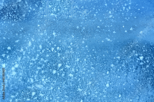 The texture of dark blue ice on the surface of the river. Ice pattern as a background.