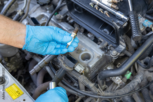 Car spark plug replacement. Repairing of vehicle.