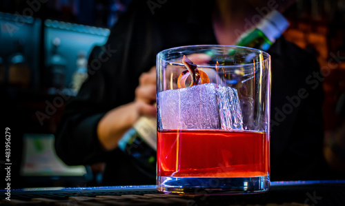 woman bartender hand making cocktail in glass on bar counter