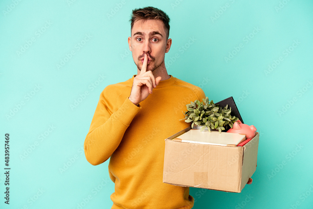 Young caucasian man making a move isolated on blue background keeping a secret or asking for silence. Young caucasian man making a move isolated on blue background keeping a secret or asking for silence.