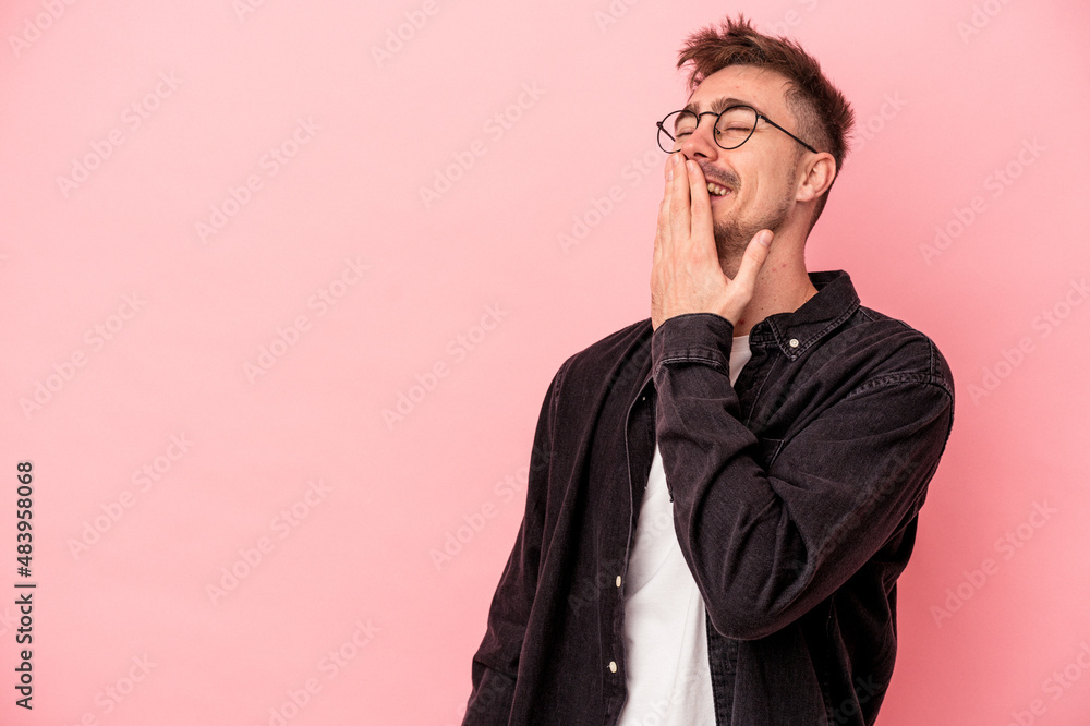 Young caucasian man isolated on pink background laughing happy, carefree, natural emotion. Young caucasian man isolated on pink background laughing happy, carefree, natural emotion.