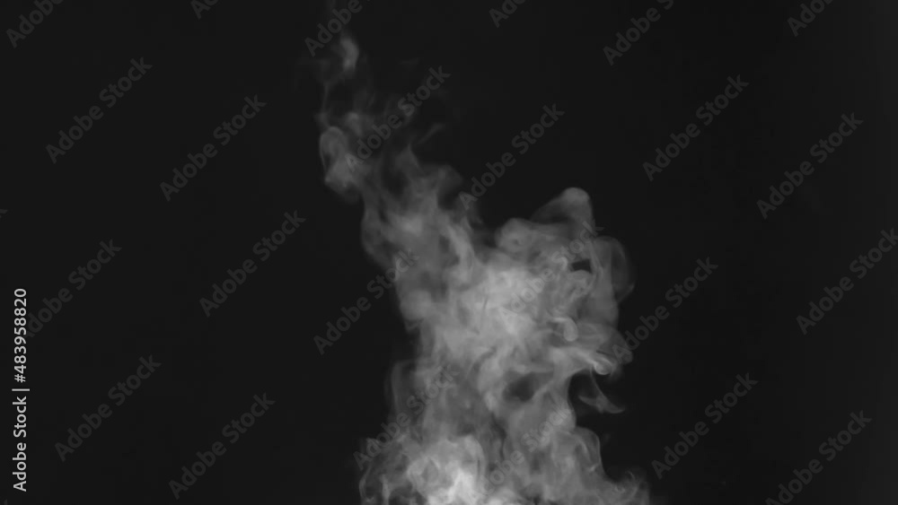 Surface of the Hot Water Creates Ssteam. A stream of white steam, slowly swirling, moves upward against a black background. Use in overlay mode to simulate the rising steam from tea, coffee or hot foo Surface of the Hot Water Creates Ssteam. A stream of white steam, slowly swirling, moves upward against a black background. Use in overlay mode to simulate the rising steam from tea, coffee or hot foo