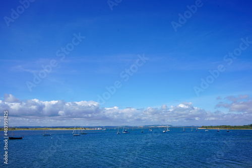 Small boats floating in blue ocean 