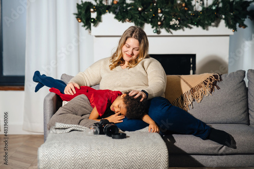 Obraz na plátně Lively mother tickling little daughter enjoy free time active weekend