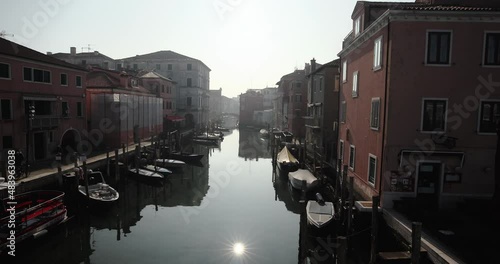 Chioggia town in venetian lagoon, water canal. Chioggia is a seaside town south of Venice, Italy. Traversed by the Corso del Popolo thoroughfare, its historic area has canals and narrow alleys.
