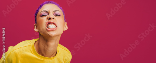 Quirky young woman making a face in a studio