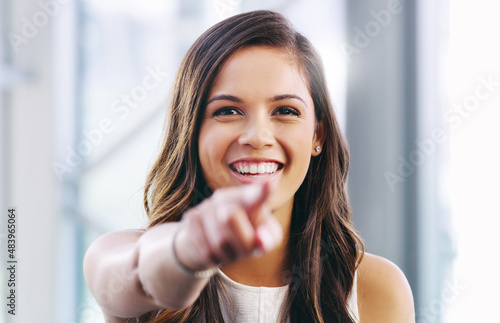 Free Download Success starts with you. Portrait of a confident young businesswoman pointing at you in a modern office. - GFXLoad