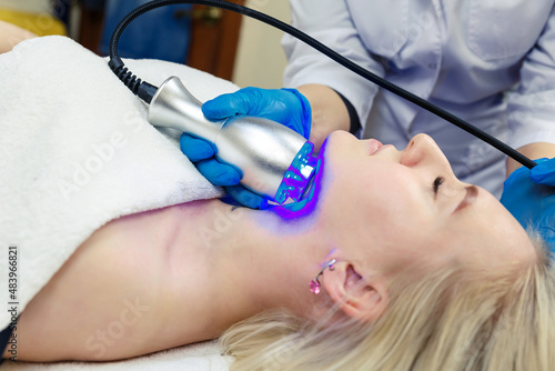 Modern facial skin rejuvenation procedures using cold cryotherapy in a beauty salon.