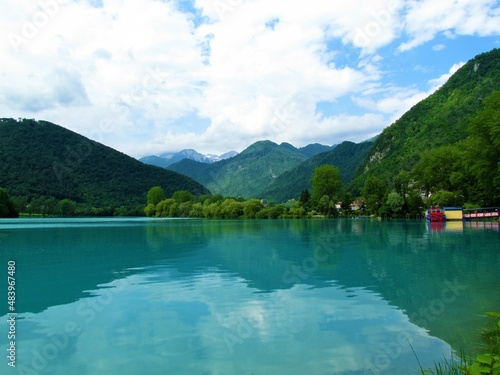 Turquoise colored lake at Most na Soci in Littoral region of Slovenia and mountains in Julian alps behind in the summer