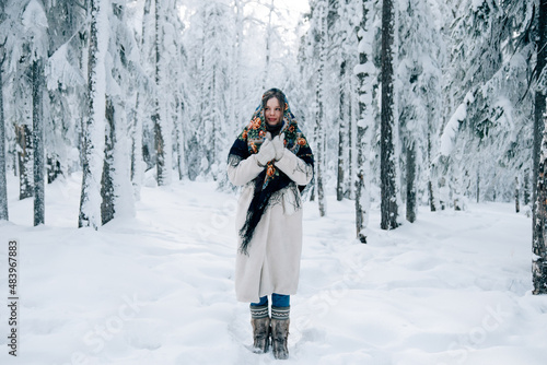 Russian beautiful girl in winter forest