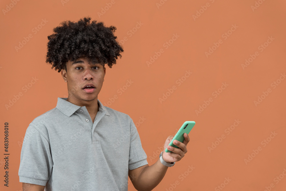 Surprised african american man looking at his mobile phone, Panama, Central America.. Surprised african american man looking at his mobile phone, Panama, Central America..