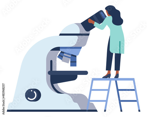 Woman looking at microscope. Laboratory worker doing research