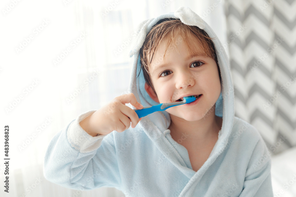 Portrait of smiling child brushing teeth with toothbrush and looking to camera. Dental hygiene of little boy, medical care, morning routine. Portrait of smiling child brushing teeth with toothbrush and looking to camera. Dental hygiene of little boy, medical care, morning routine.