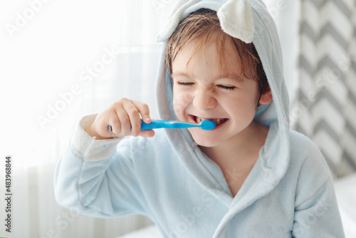 Dental hygiene of little boy  medical care. Smiling happy child brushing teeth with toothbrush.