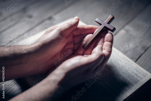 Fotografiet Praying with the bible and holding religious crucifix cross