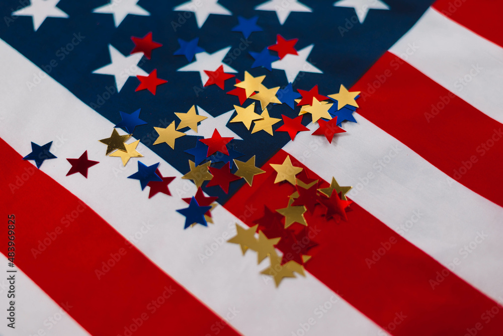 Fototapeta premium Colored shiny stars on American Flag Background. Expression of Patriotism and Love for their Country, the United States. Independence Day is July 4. Memorial Day