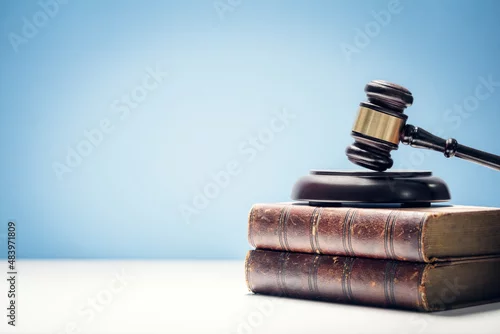 Obraz Judge gavel and law books in court background with copy space