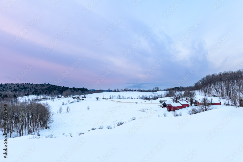 Photograph of a farm during a winter sunrise