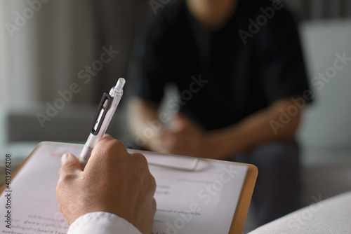 Professional psychologist wearing white shirt conducting a consultation.