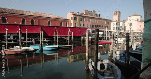 Chioggia town in venetian lagoon, water canal. Chioggia is a seaside town south of Venice, Italy. Traversed by the Corso del Popolo thoroughfare, its historic area has canals and narrow alleys.