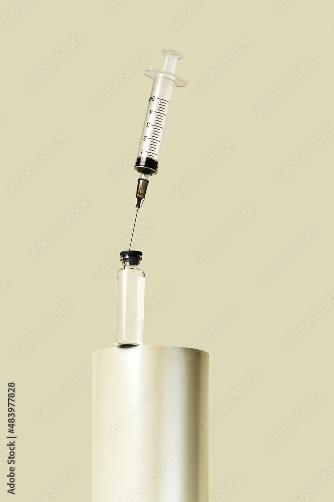 Transparent glass jar with disposable syringe on a pastel background. Medical concept of prevention, immunization, vaccination and treatment of coronavirus infection Transparent glass jar with disposable syringe on a pastel background. Medical concept of prevention, immunization, vaccination and treatment of coronavirus infection