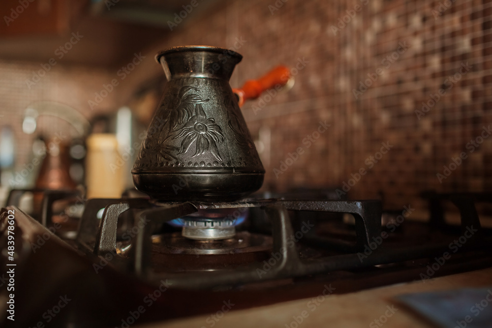 coffee is brewed on the stove in jezve coffee is brewed on the stove in jezve