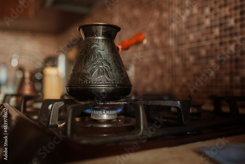 coffee is brewed on the stove in jezve 