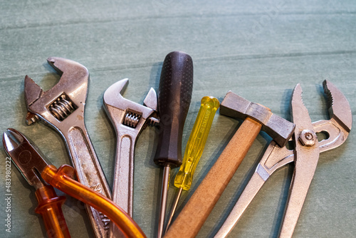 Fotografie Screwdrivers, wrenches, pliers, hammer and spanner on a table