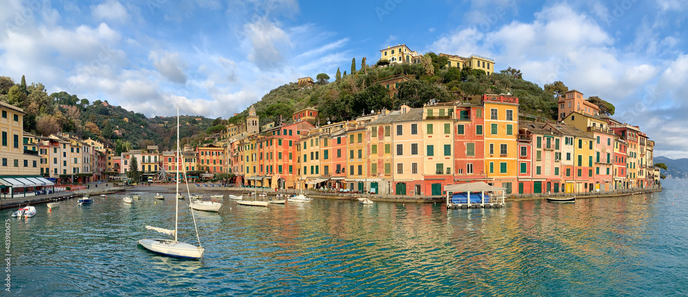 Portofino panorama with colourful houses, boats in harbour, wide-angle panoramic shot