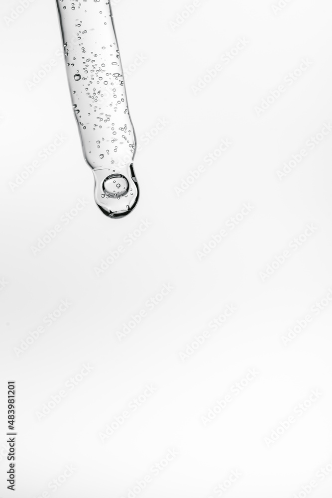 Transparent pipette with cosmetics on a white isolated background.