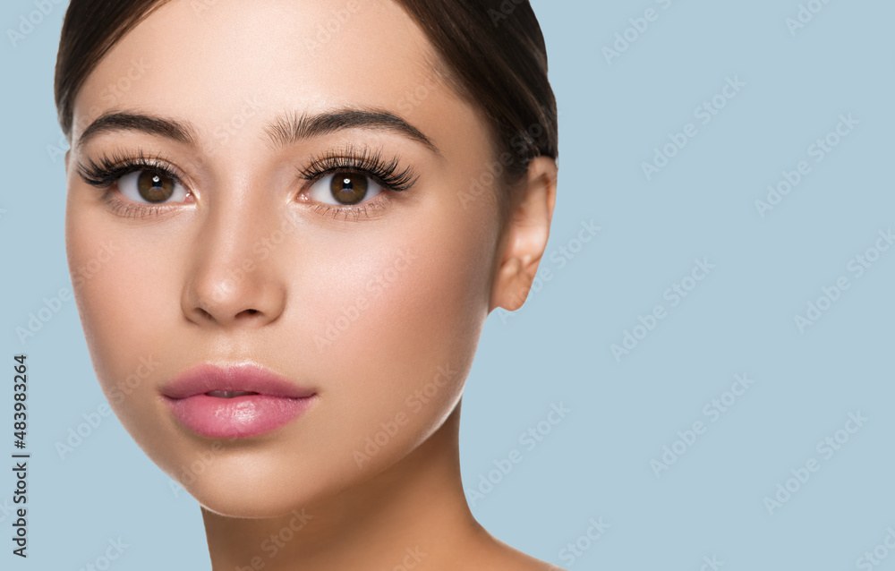 Freckle face woman with healthy beauty skin big lashes and beautiful eyes. Color background.