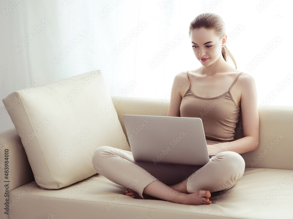 Woman with laptop on sofa working home alone lifestyle. Woman with laptop on sofa working home alone lifestyle.