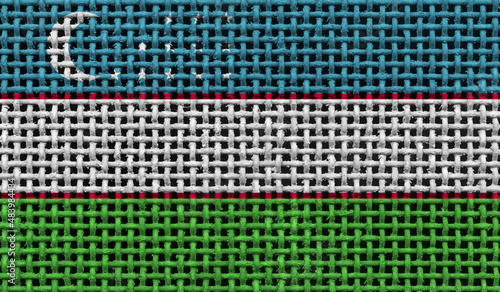 Uzbekistan flag on the surface of a metal lattice. 3D image