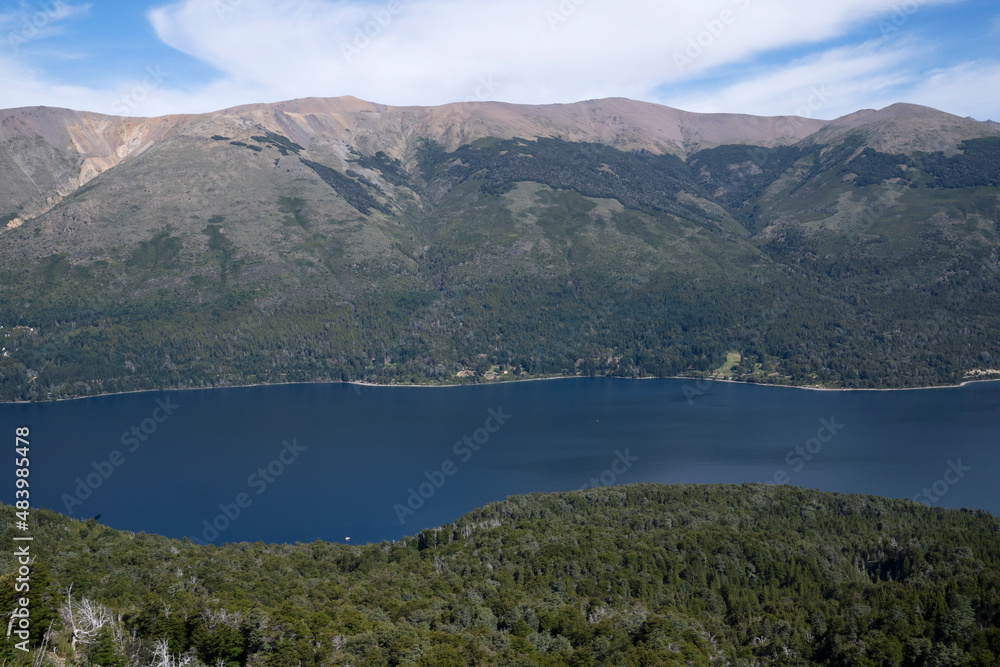 View of the forest, blue water Gutierrez lake and Catedral hill in Bariloche, Patagonia Argentina. 
