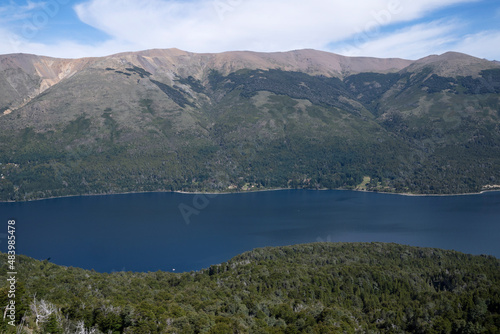 View of the forest, blue water Gutierrez lake and Catedral hill in Bariloche, Patagonia Argentina.  photo