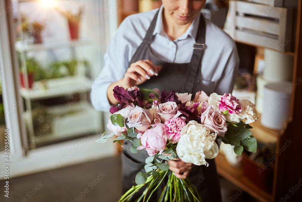 Happy florist with fresh bouquet