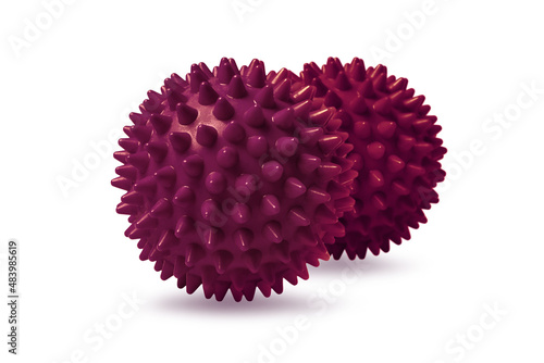 Two red spiny massage balls isolated on white. Concept of physiotherapy or fitness. Closeup of a colorful rubber ball for dog teeth on a white color background. Corona virus model.