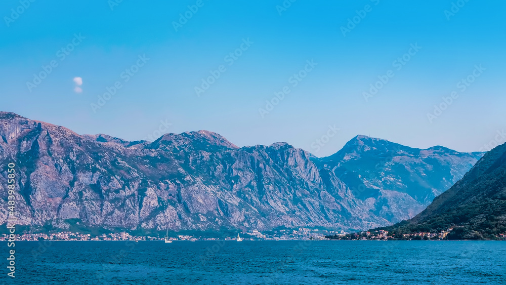 Panorama view of Mediterranean seashore. Seascape. Sea, mountains and clouds. Background for travel banner