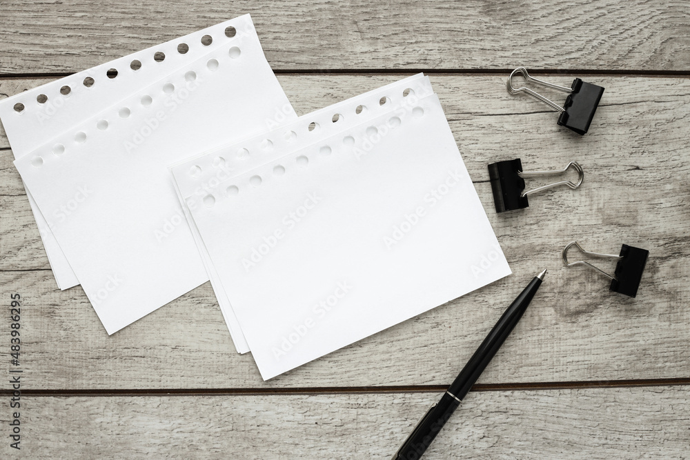 sheets of paper on a wooden table. Wallpaper use for education, business photo. Make a product note for a book with paper and concept, object or copy space. sheets of paper on a wooden table. Wallpaper use for education, business photo. Make a product note for a book with paper and concept, object or copy space.