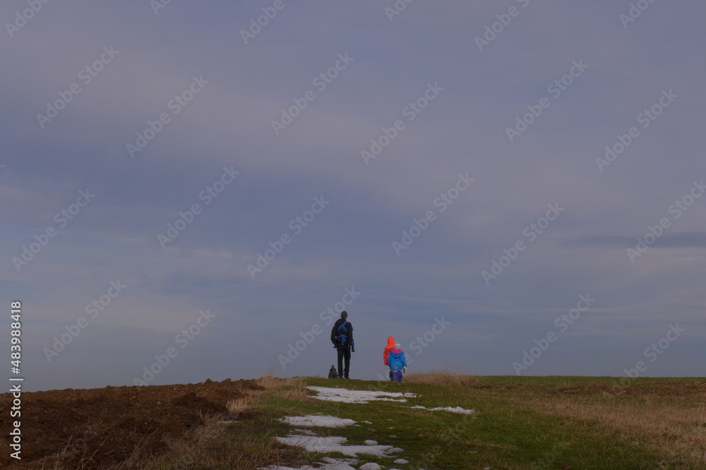 daddy and kids walking in the countryside