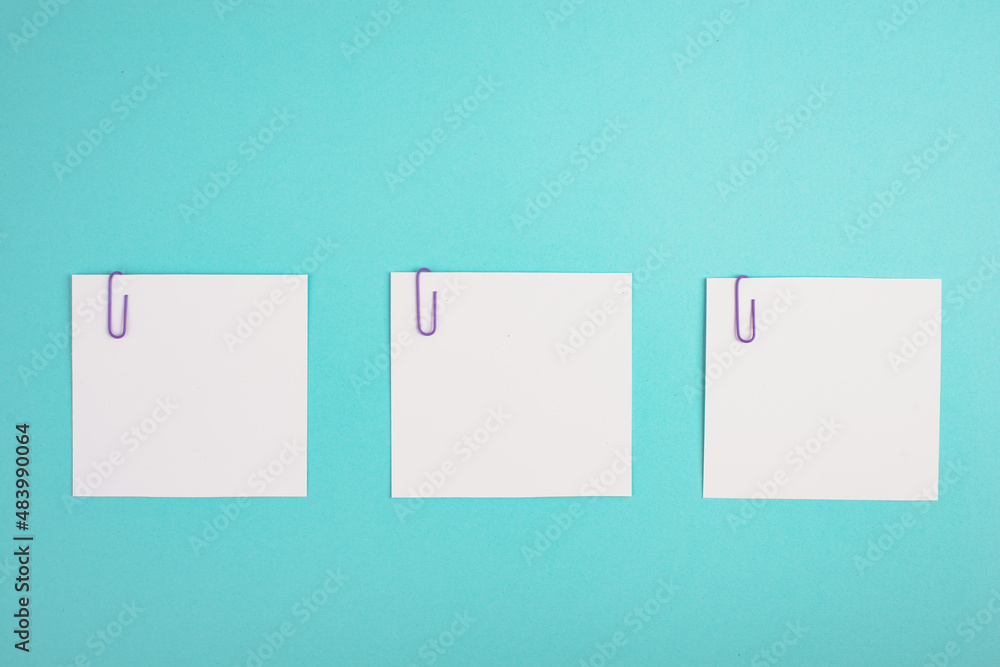 Empty white paper pinned on a blue colored background, bulletin note, rreminder, empty copy space Empty white paper pinned on a blue colored background, bulletin note, rreminder, empty copy space