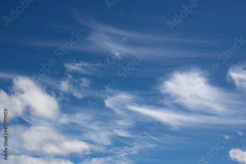 Beautiful sky background. Unusual cirrus clouds in the blue sky