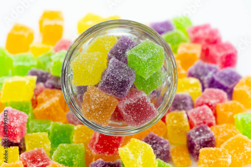 Cube jelly candy in container and the floor. Circle glass contained sweetie candy.