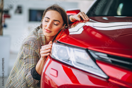 Beautiful woman hugging a car